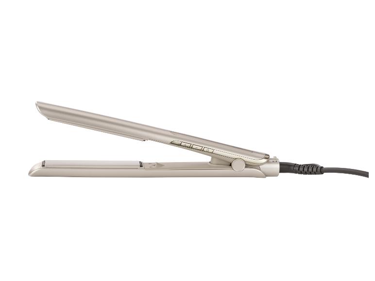 Een beige stijltang met bedieningsknoppen en een zwart snoer.