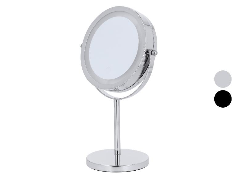 Ronde chromen make-upspiegel met LED-verlichting en stabiele voet.