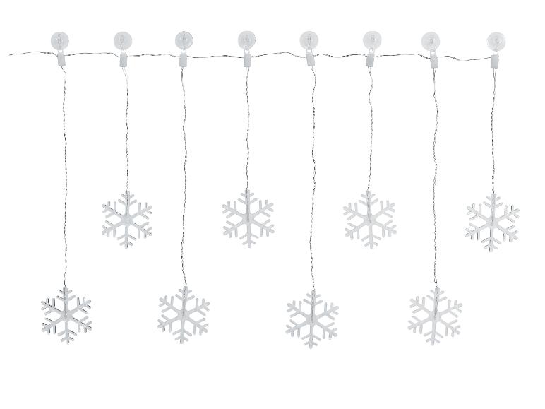 Verlichte slinger met acht zilveren sneeuwvlokken hangend aan zuignappen.