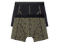 Twee paar boxershorts, een zwart en een met een tropisch printje.