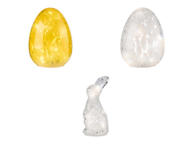 Twee glazen eieren met lichtjes en een konijn.
