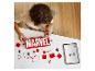 Een kind bouwt een LEGO Marvel logo met rode en witte stenen, met een tablet met instructies.