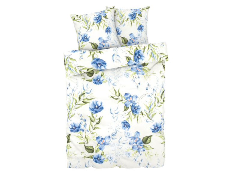 Een wit dekbedovertrek met blauwe bloemen en bijpassende kussenslopen.