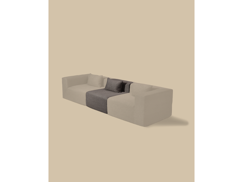 Modulaire bank met lichtbeige en donkergrijze secties en kussens.