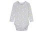 Een grijze baby romper met gele en witte stippen van Lupilu.