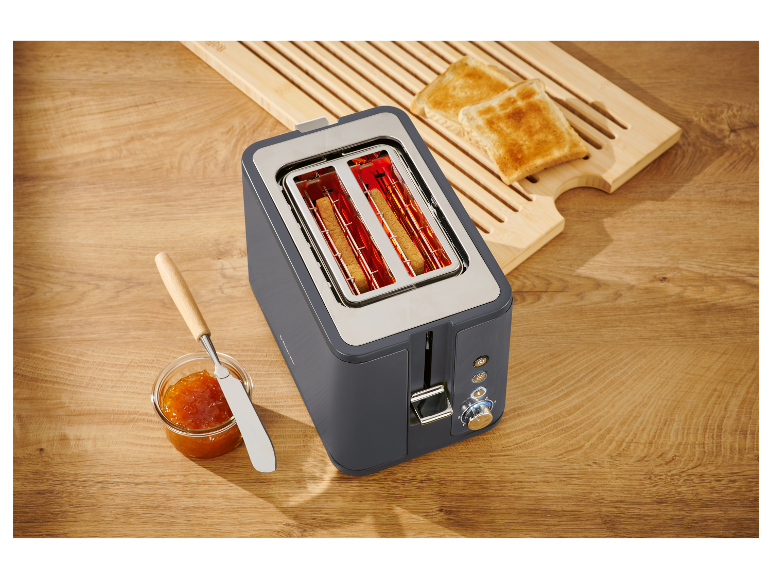 Een donkergrijze broodrooster met twee sneetjes brood die worden geroosterd.