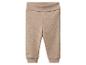 Beige babybroek van geribbeld breisel met omvouwbare tailleband.