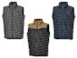 Drie Parkside bodywarmers in grijs, zwart en blauw.