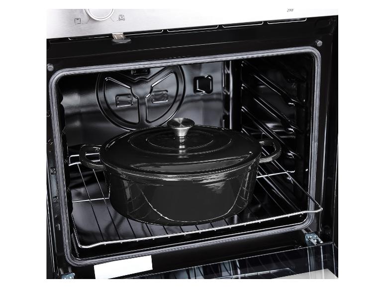 Zwarte gietijzeren pan met deksel in een oven
