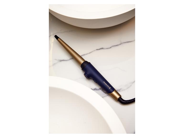 Remington krultang, goud en donkerblauw, op marmer.