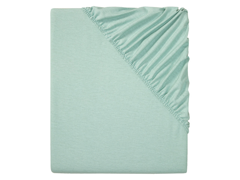 Een lichtgroene hoeslaken met elastiek.