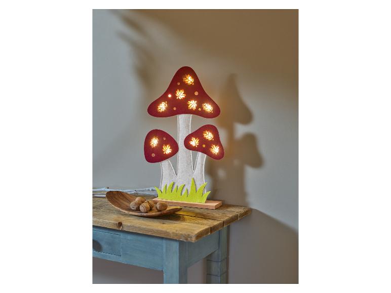 Houten lamp in de vorm van paddenstoelen met LED-verlichting, op een tafel.