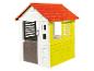 Een wit en geel speelhuis met een rood dak van Smoby.