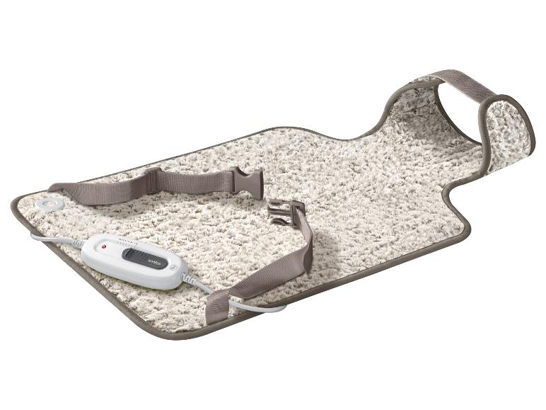 Wit, pluizig elektrisch deken met Sanitas afstandsbediening en bevestigingsriemen.