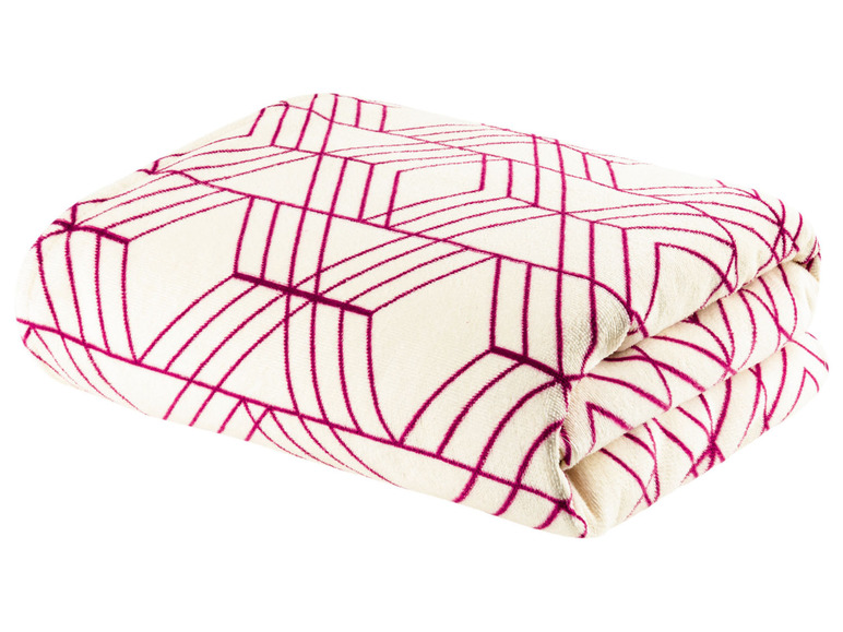 Gevouwen deken met geometrisch patroon in roze en wit.