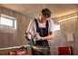 Man snijdt metalen pijp met haakse slijper, vonken vliegen.