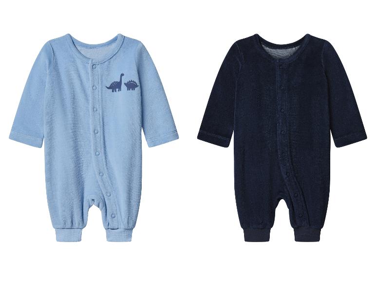 Twee velours babyrompers, één lichtblauw met dinosaurussen en één marineblauw