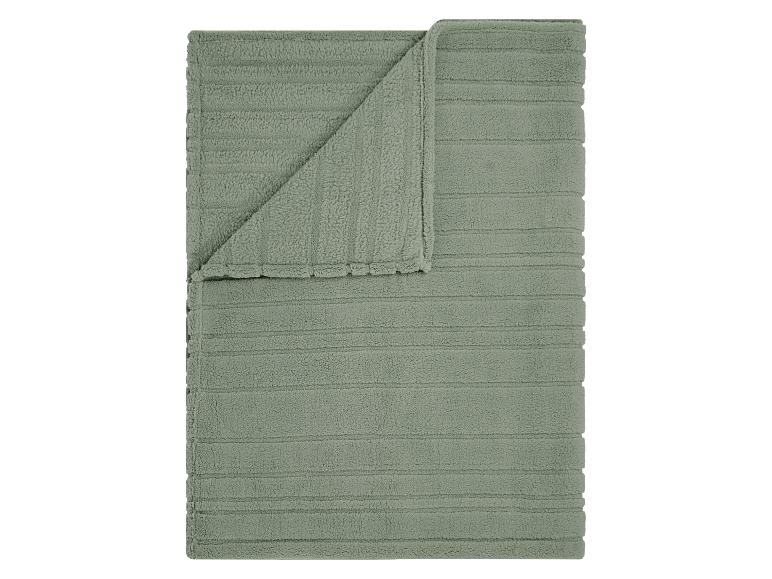 Groene, gestreepte badmat, opgevouwen