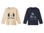 Twee langarmige shirts voor kinderen: een beige met een hond en de tekst 'Beste vriend', en een donkerblauwe met een tractor en de tekst 'Tractor avontuur'.