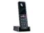 Zwarte draadloze telefoon met oplaadstation en numeriek toetsenbord.