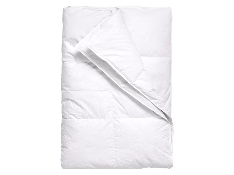 Wit dekbed opgevouwen met een omgeslagen deel, op een witte achtergrond.