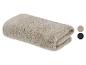 Gevouwen beige handdoek met geribbelde textuur, toont twee kleurstalen: beige en zwart.