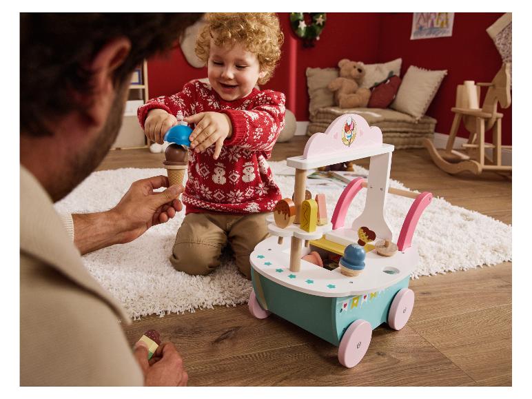 Een vader en kind spelen met een houten ijscokar.