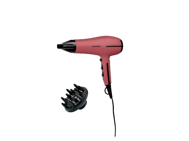 Een roze Silvercrest föhn met een diffuser.