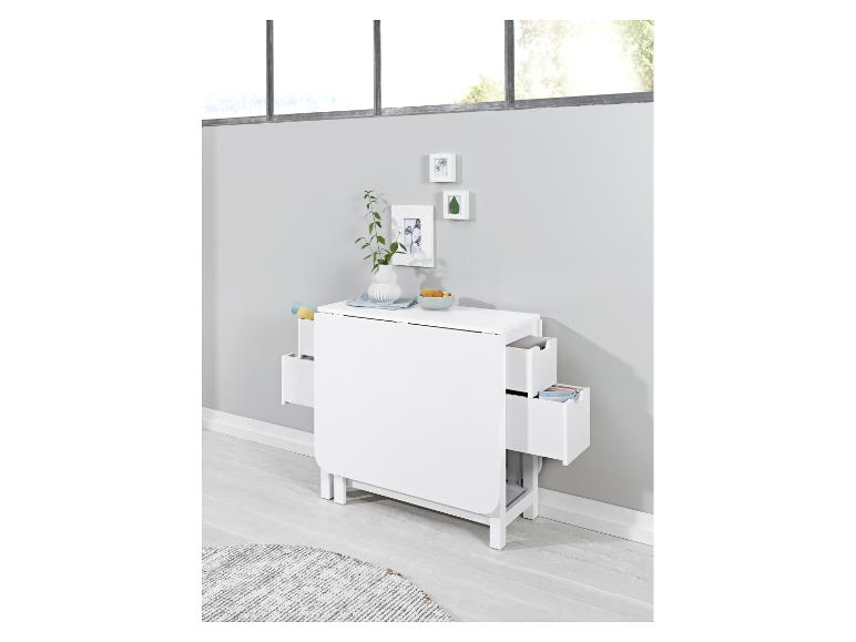 Een witte opklaptafel met laden in een lichte kamer.