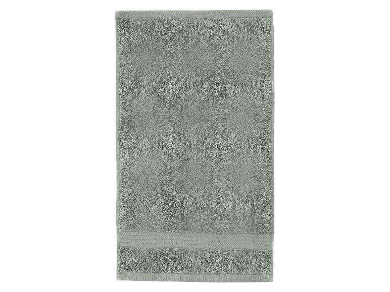 Een enkele, rechthoekige, lichtgroene handdoek met een gestructureerd oppervlak.