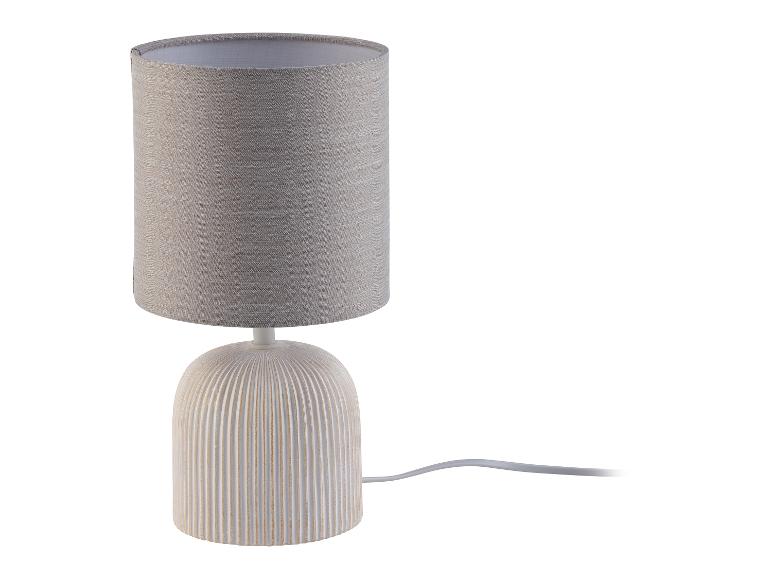 Beige tafellamp met een stoffen kap en keramische voet.