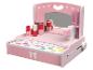 Roze kinderkaptafel met spiegel, cosmetica en accessoires.