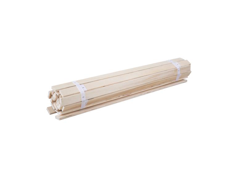 Een set houten bedlatten, opgerold en vastgebonden met witte banden.