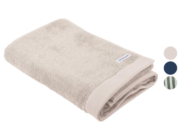 Beige handdoek met logo en stalen van kleuropties.