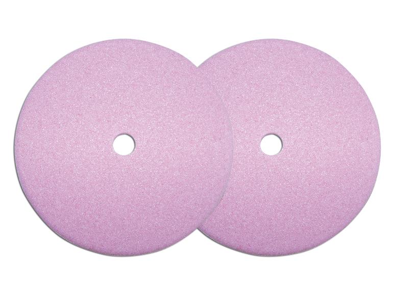 Twee roze slijpschijven met een gat in het midden.