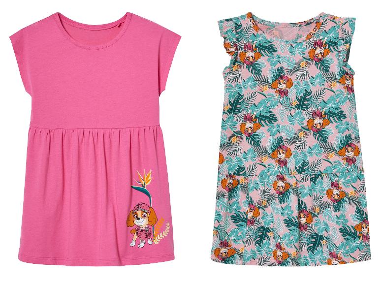 Twee meisjesjurkjes: een effen roze jurkje met Skye van Paw Patrol, een roze jurkje met tropische print.