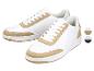 Witte sneakers met beige details en veters, met kleurstalen voor beige en donkerblauw.
