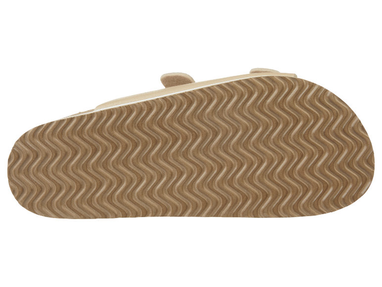 Beige zool van kindersandalen met een golvend patroon.