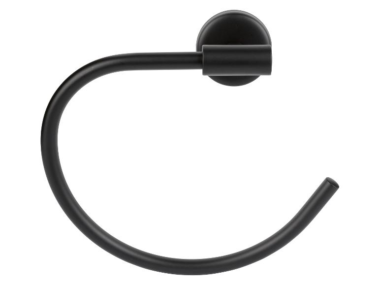 Een zwarte ringvormige handdoekhouder, gemonteerd aan de muur.