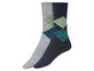 Twee paar sokken met een argyle patroon in grijs en donkerblauw.