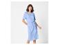 Lachende vrouw in een blauwe jurk met een knoop in de taille.