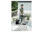 Man reinigt barbecue met aszuiger op terras.
