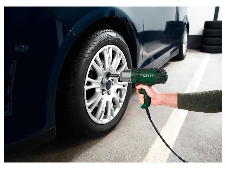 Een persoon gebruikt een Parkside slagschroevendraaier om een autowiel te verwisselen.