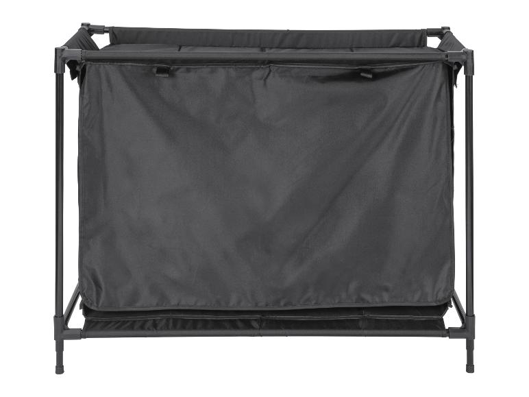 Opvouwbare wasmand met zwarte stof en metalen frame.
