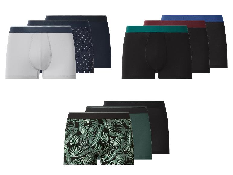 Herenboxershorts in diverse kleuren en patronen, waaronder wit, zwart, met geometrische en bladprints.