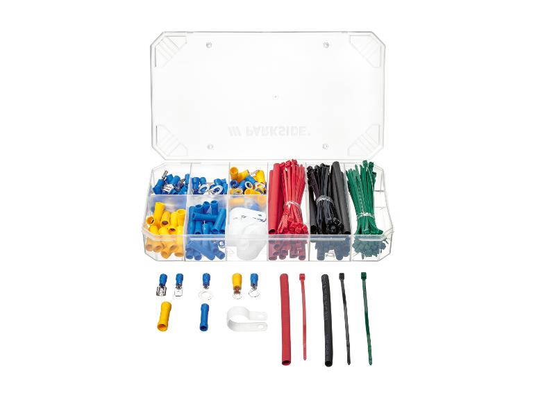 Set elektrische klemmen en kabelbinders in een doorzichtige doos, met tekst op het deksel.
