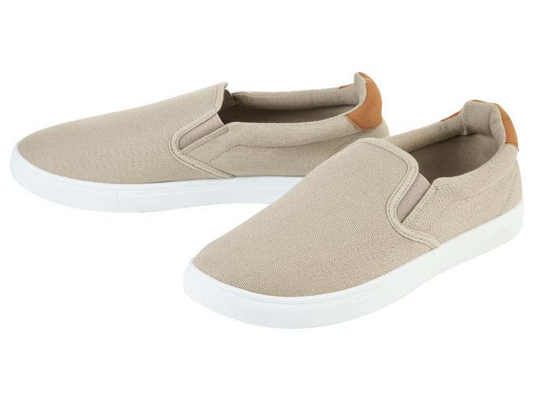 Beige canvas slip-on sneakers.