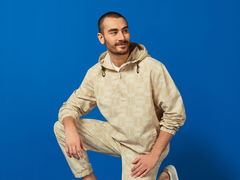 Een man in een beige Lidl-jack en broek.