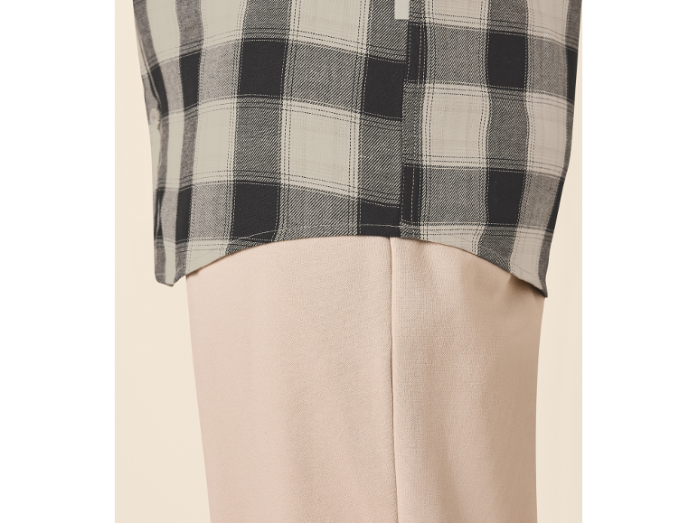 Geruit overhemd en beige broek.