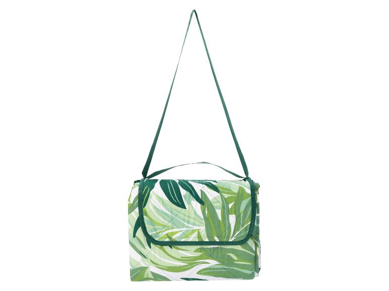 Groen-wit picknickkleed met bladpatroon en schouderband.